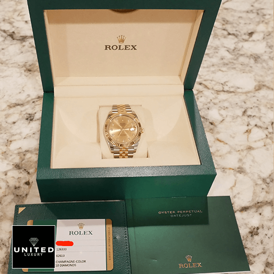 Rolex 126333 Yellow Gold Diamond Jubilee Inspired in the box next to warranty card