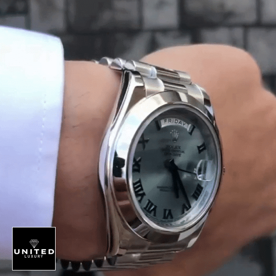 the man has a Rolex Day-Date II Stainless Steel Ice Blue Roman Dial 218206 Inspired